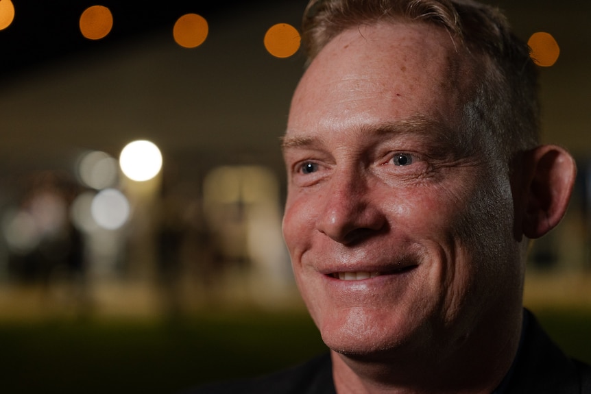 A close up of a mans face.