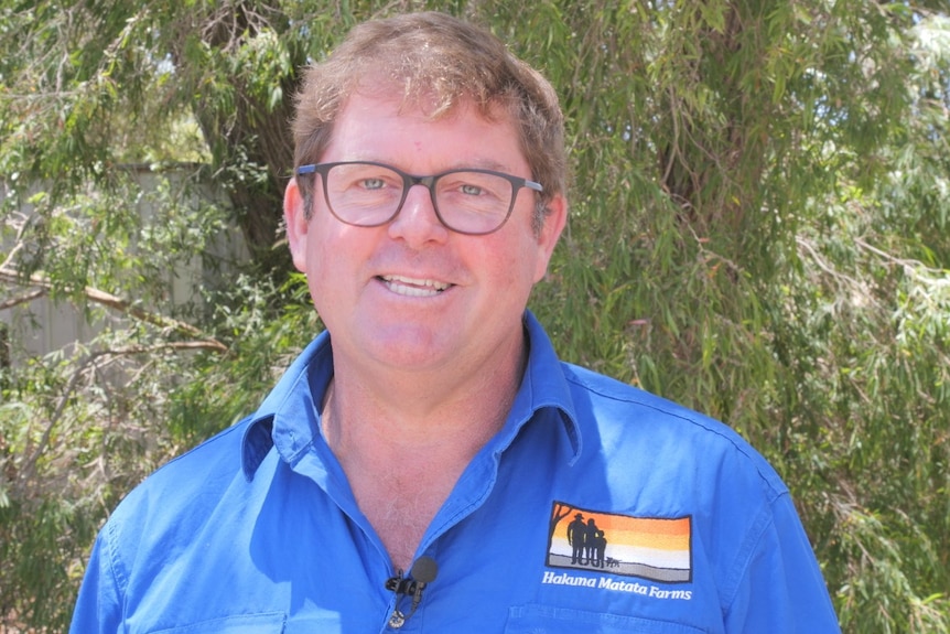 a man smiles to the camera