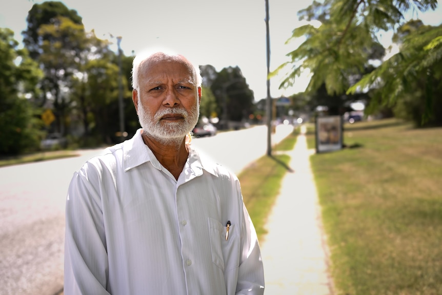 A worried-looking man next to a road