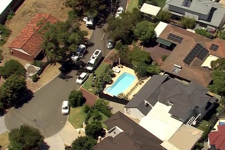 Aerial photos of a suburban street with white vehicles parked