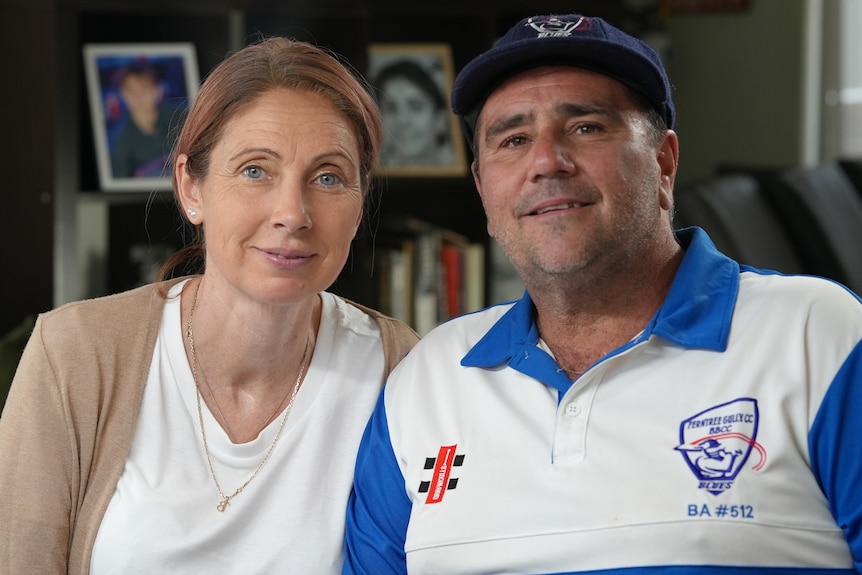 A woman and a man sit next to each other.