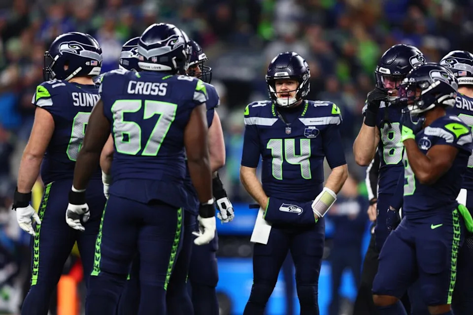 Jan 17, 2026; Seattle, WA, USA; Seattle Seahawks quarterback Sam Darnold (14) in the huddle against the San Francisco 49ers during the first half in an NFC Divisional Round game at Lumen Field. Mandatory Credit: Kevin Ng-Imagn Images