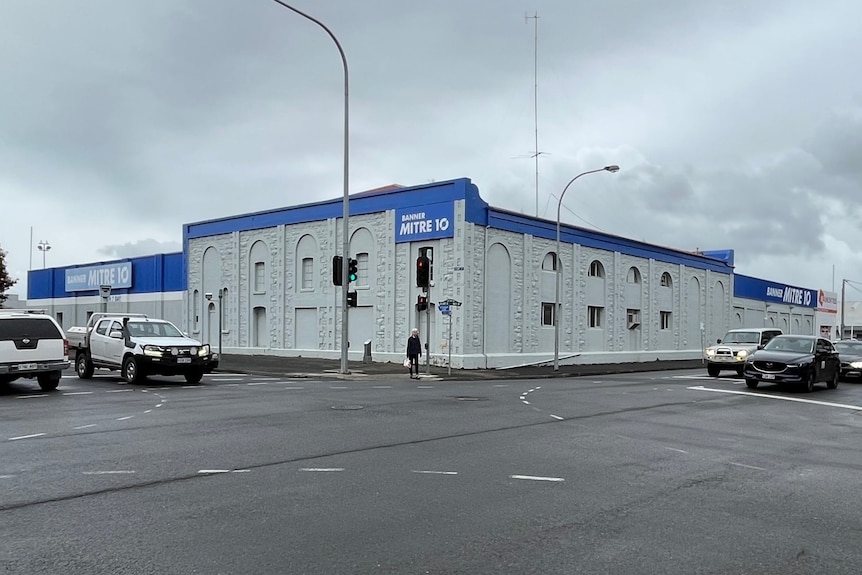 A large white and blue hardware store in a heritage building