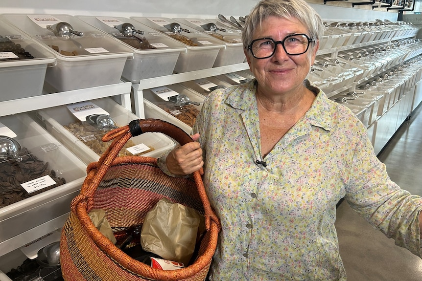 woman with shopping basket in bulk foods store