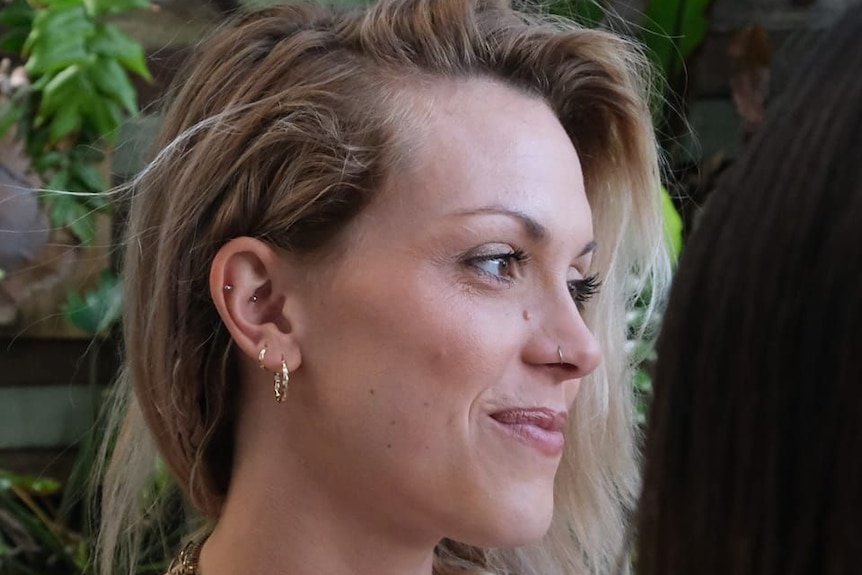 A headshot of a young woman with blonde hair looking off camera.