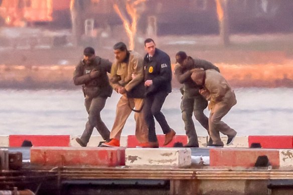 Maduro arrives at the heliport ahead of his transfer by vehicle to the courthouse.