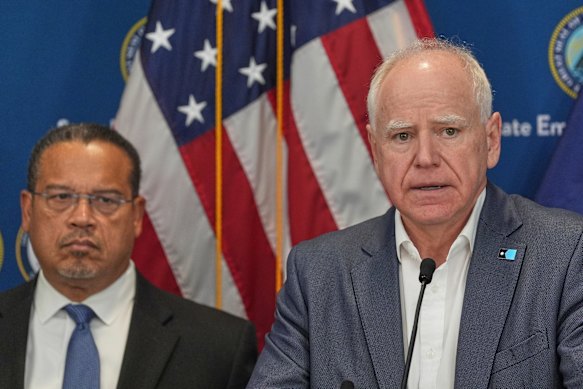Minnesota Governor Tim Walz, right, and Attorney-General Keith Ellison discuss the shooting.