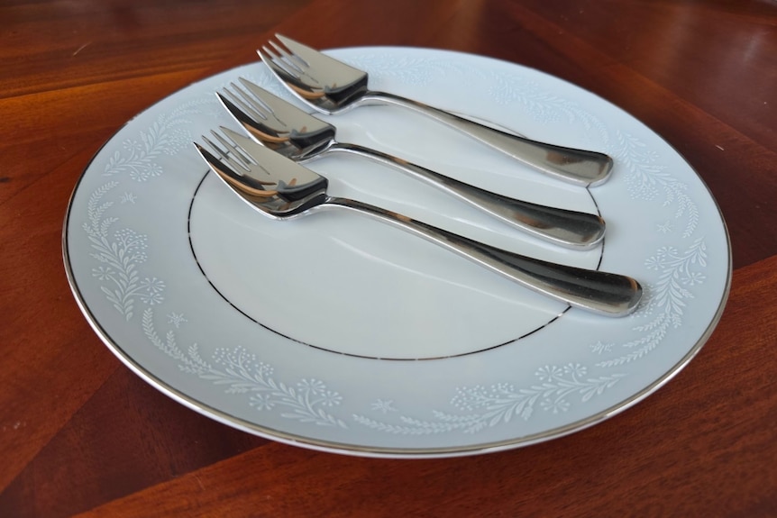 Three silver Splayds rest on a plate. 