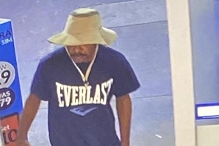 A man in a hat enters a service station