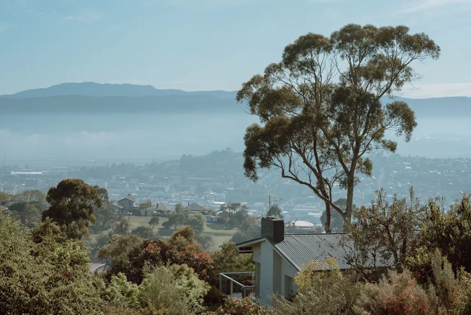 Wenyi Liu / Getty Images Launceston emerges from the morning mist, with the North Esk River winding toward the Tamar Valley beyond. Tasmania's northern city offers retirees historic charm, compact walkability, and the lowest median home price of any destination on this list.