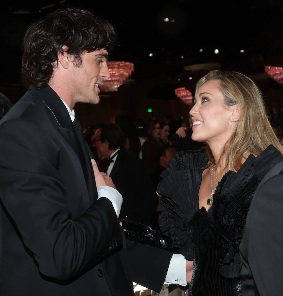 Jacob and Miley Cyrus speaking at an event