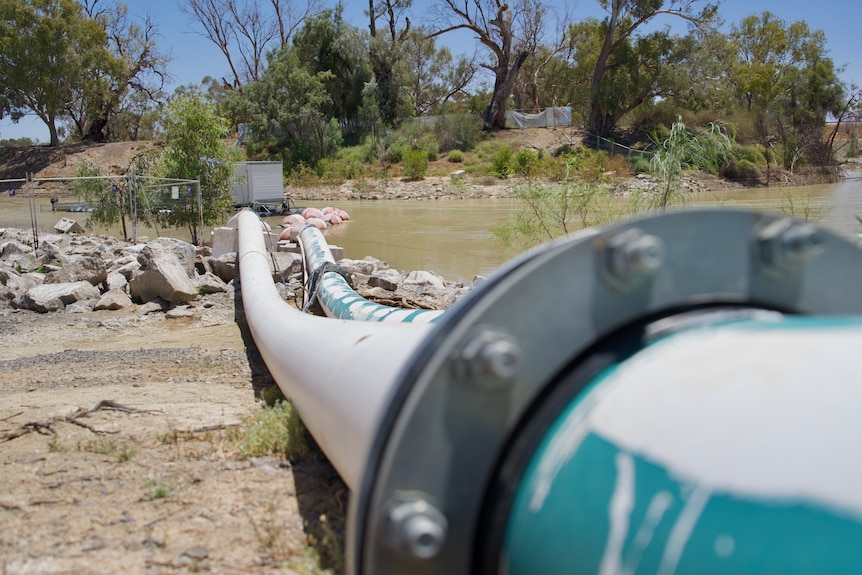 A pipe leading from the Darling River over a road and into the Menindee Lakes