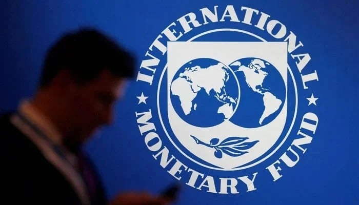 A man walks past the International Monetary Fund (IMF) logo. —Reuters/File