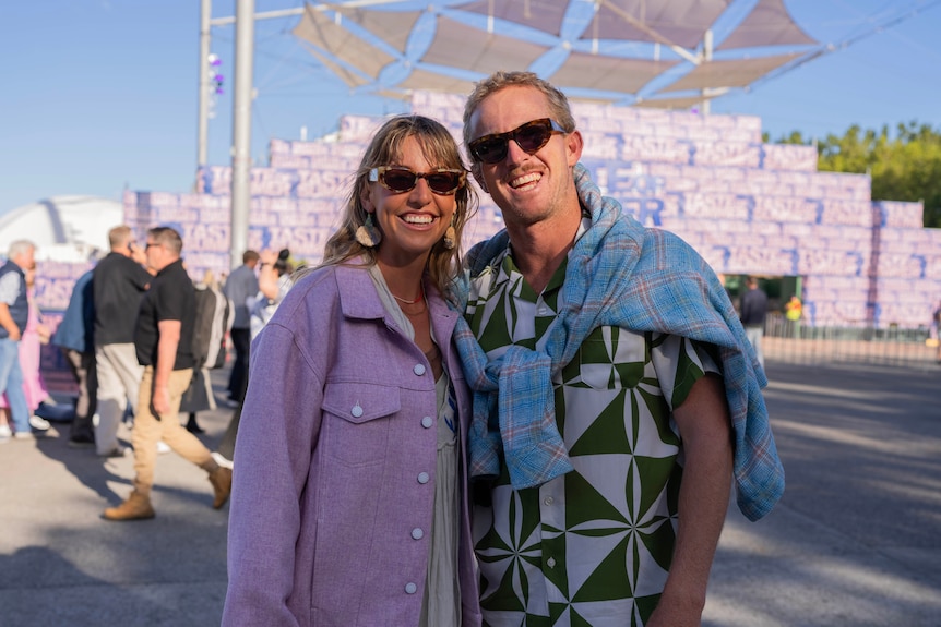 A couple smiling at the camera