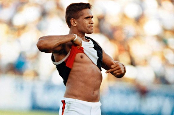 St Kilda player Nicky Winmar points to his skin in response to a racist taunt from the crowd in 1993.