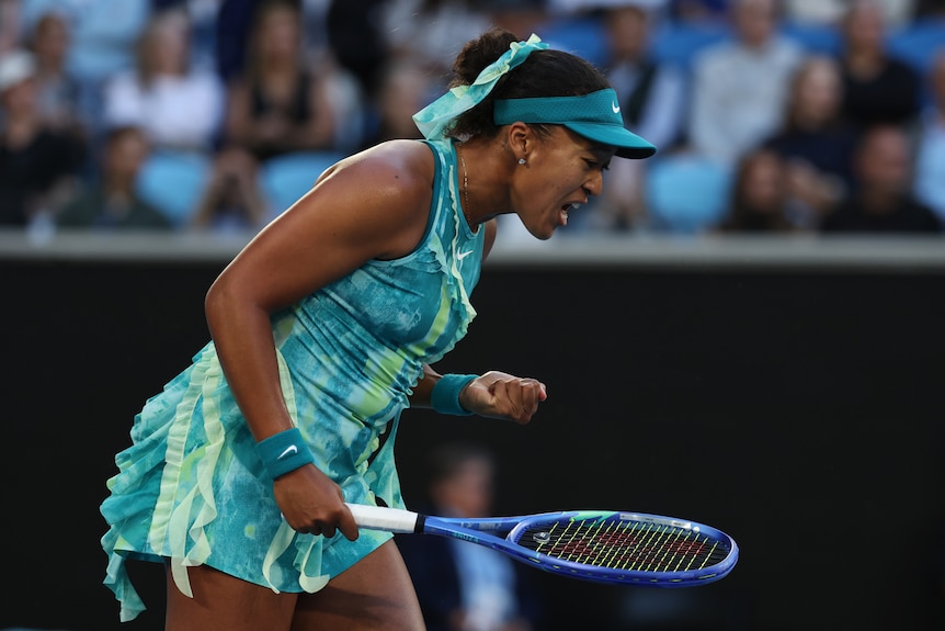 Naomi Osaka pumps herself up after winning a point