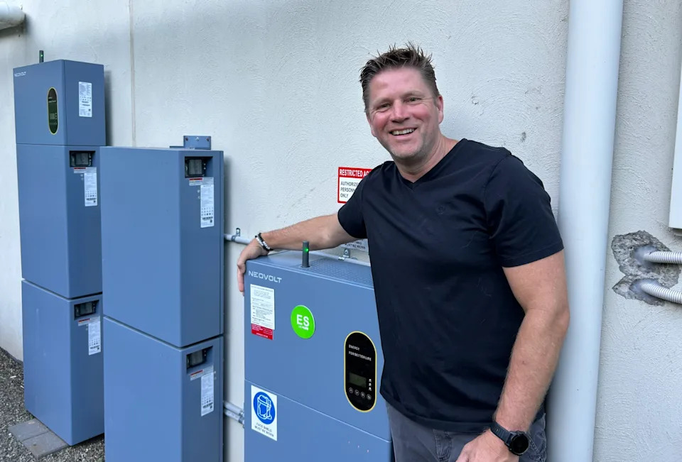 Rob Tooze beside his home batteries. 