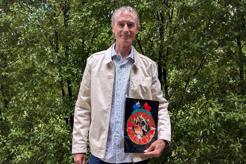 A man smiles at the camera.