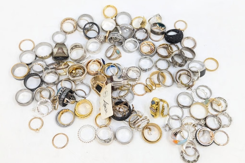 A table full of gold and silver ring on the table.