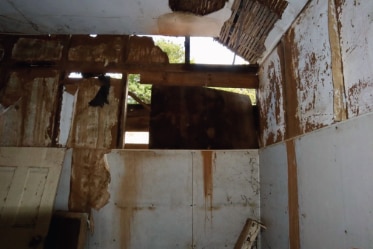 Damaged panelling and windows inside the historic homestead captured in Mr Lyon's report.