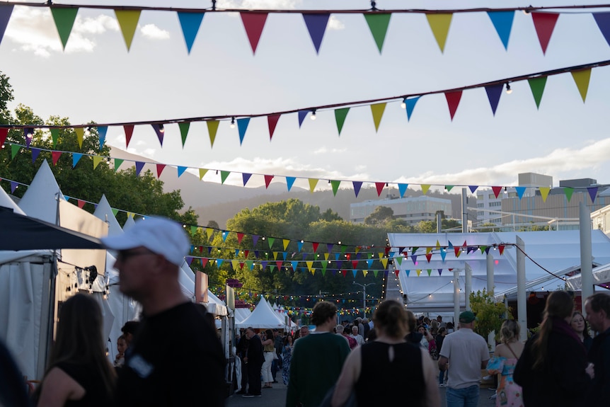 People gathering at a big colourful music and food festival.