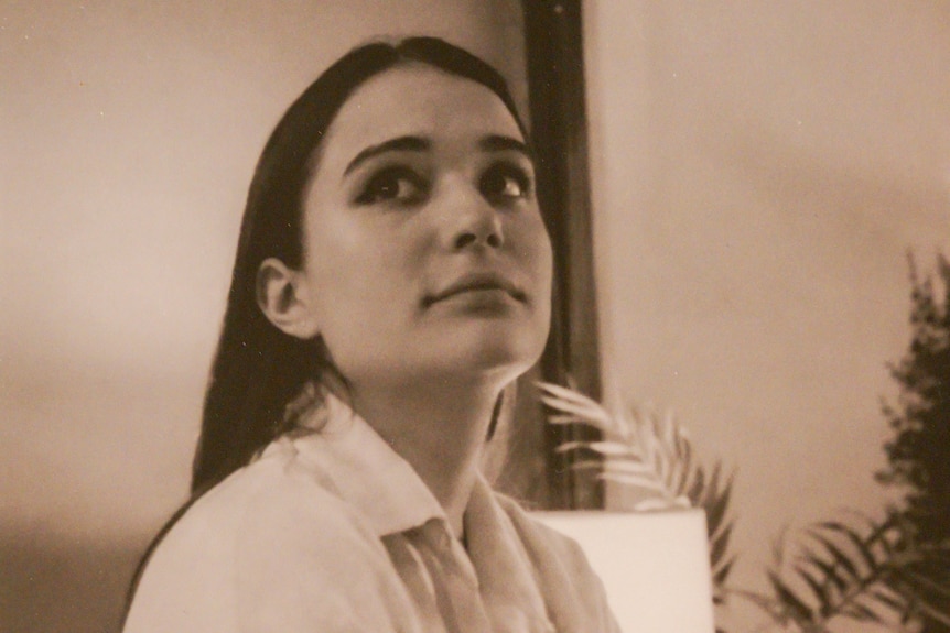 A black and white photo of a young woman.