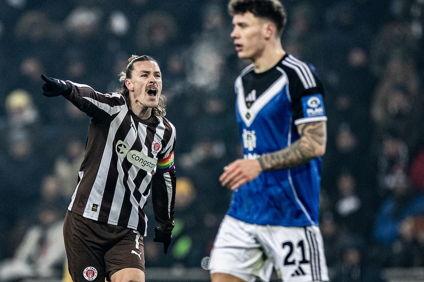 Jackson Irvine gestures during a Bundesliga match for St Pauli 