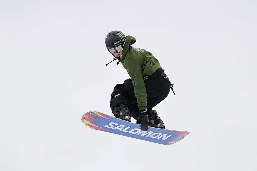 Tess Coady grabs her snowboard.