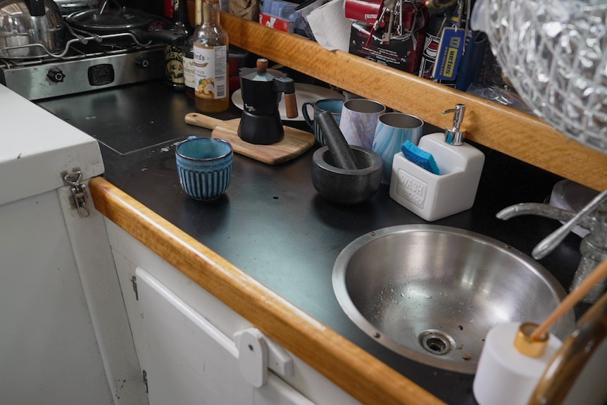 Photo of a small kitchen with sink inside a small yacht
