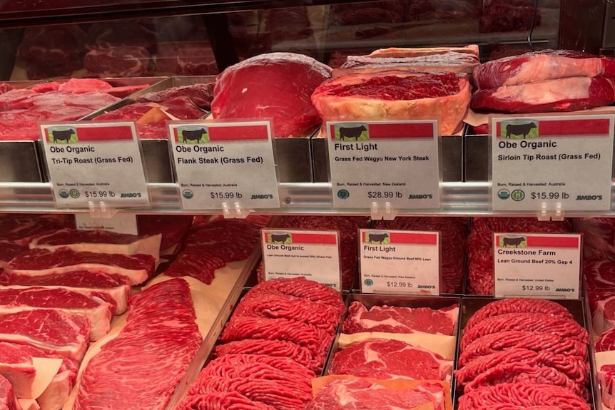 Shelves of Australian beef in a refrigerated cabinet in a US butcher shop.