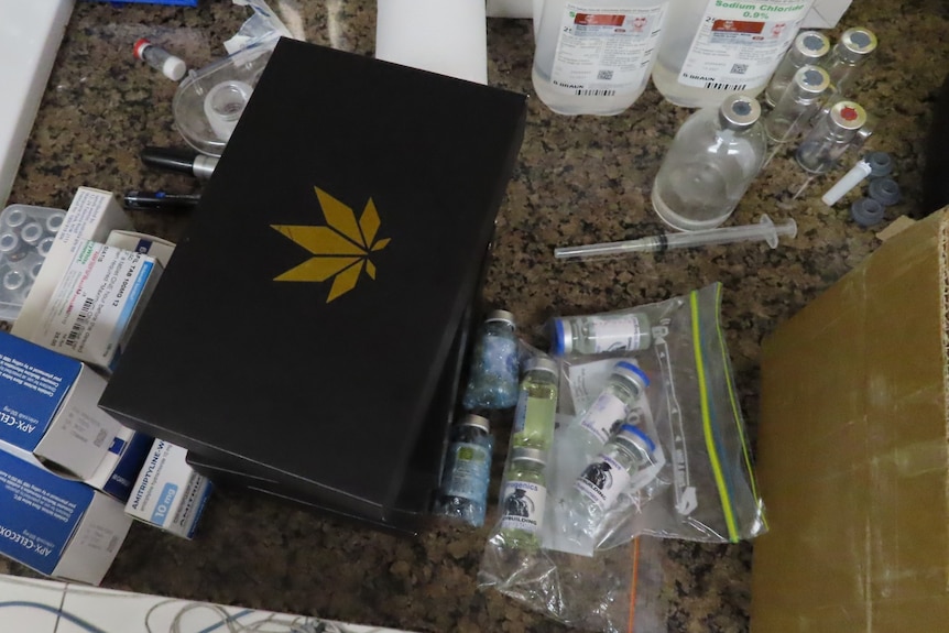 Medication in plastic bags and a sleeve with a marijuana leaf design on it.