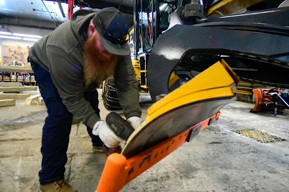 Tim O’Connell, a grader operator in Brattleboro, Vermont, gets his vehicle ready ahead of the storm on Friday.