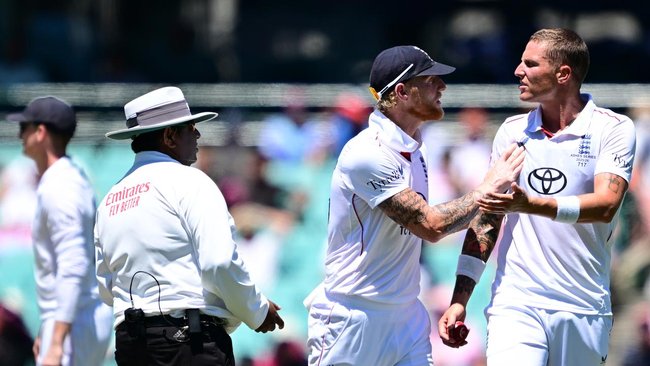 Bryson Carse is held back by skipper Ben Stokes as  he tries to engage umpire Ahsan Raza. 