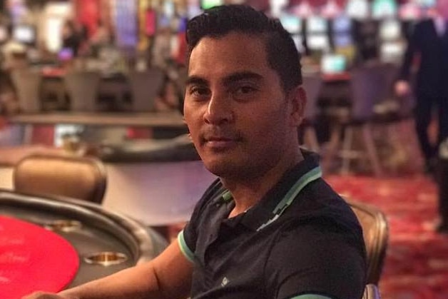 A man in his 40s sitting at a gambling table in casino