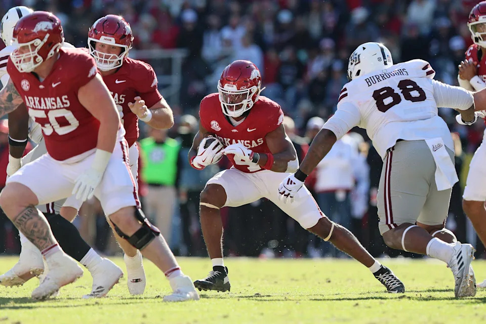 Nov 1, 2025; Fayetteville, Arkansas, USA; Arkansas Razorbacks running back Mike Washington Jr (4) rushes during the first quarter against the Mississippi State Bulldogs at Donald W. Reynolds Razorback Stadium. Mandatory Credit: Nelson Chenault-Imagn Images