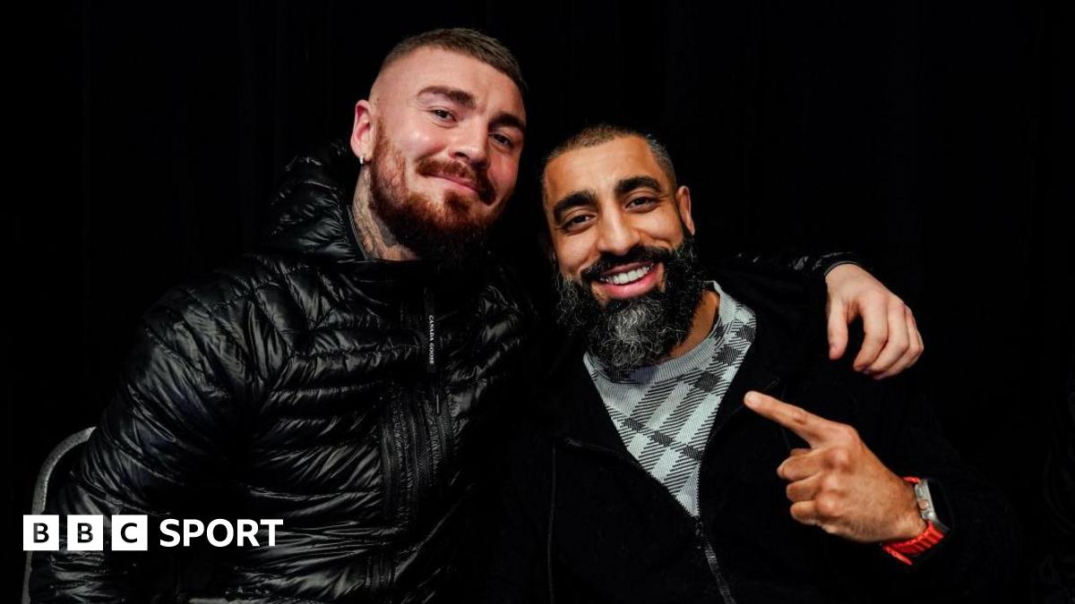 Lewis Crocker and Huzaifah Iqbal embrace while posing for a photo