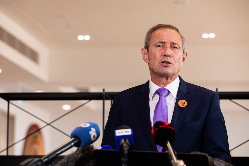 Roger Cook speaks at a press conference.