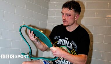 Dalton Smith in the changing rooms looking at his WBC world title