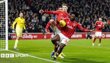 Nottingham Forest defender Ola Aina appears to control the ball with his arm inside the penalty area