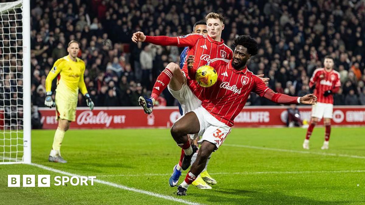 Nottingham Forest defender Ola Aina appears to control the ball with his arm inside the penalty area
