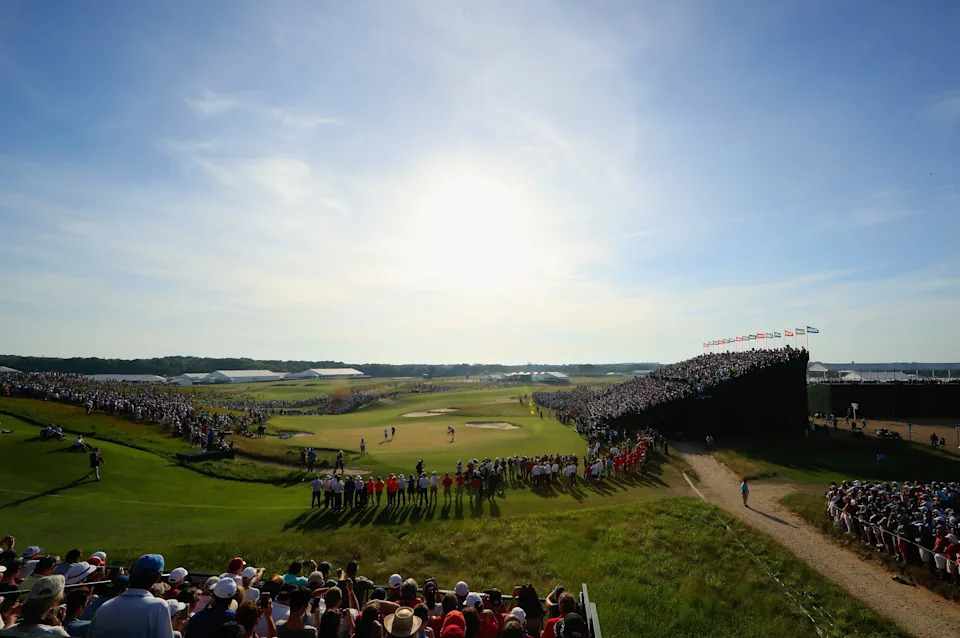 Brooks Koepka of the United States putts on the 18th green as a crowd looks on during the final round of the 2018 U.S. Open at Shinnecock Hills Golf Club on June 17, 2018 in Southampton, New York.