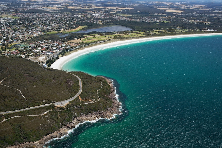 An aerial shot of coastline with a road and footpath