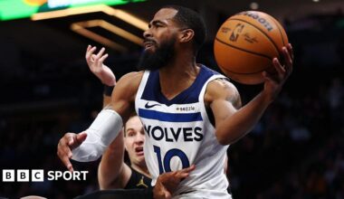 Mike Conley holds a basketball in his hand