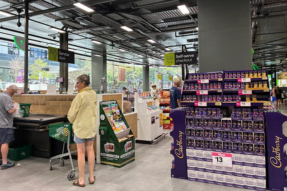 Woman queues to pay at a Woolworths in Sydney.