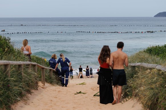 Thousands of people lined Long Reef Beach for a paddle-out in memory of shark attack victim Mercury Psillakis in September.