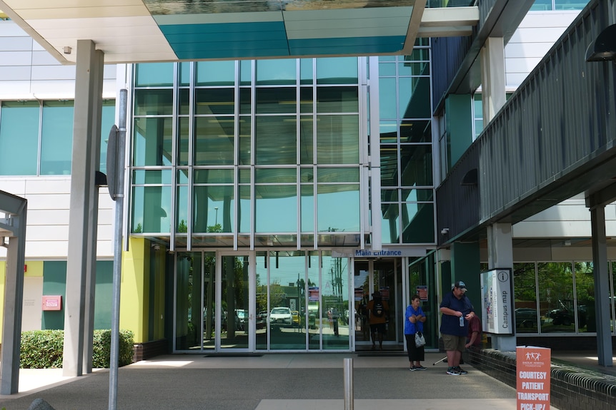A covered walkway, with a large glass door at the end