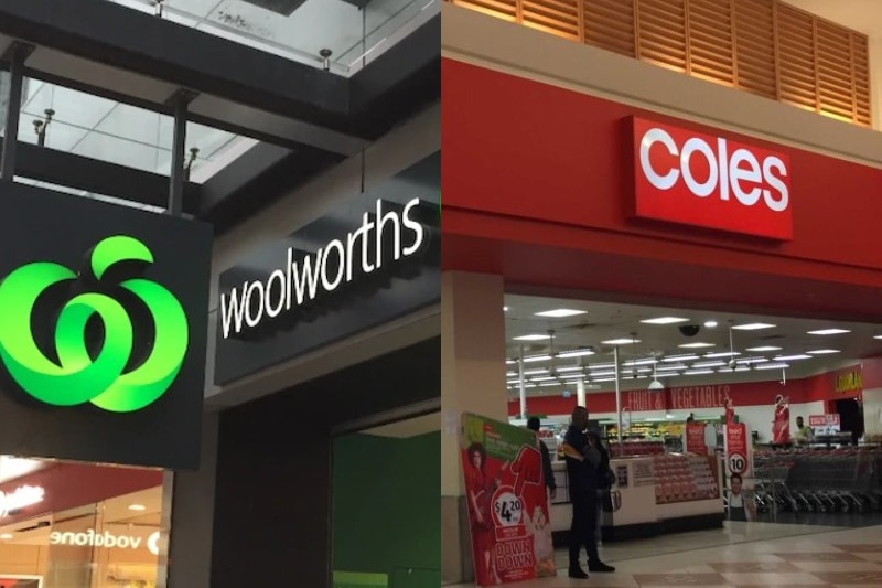 A Woolworths sign next to a Coles sign outside the shops.
