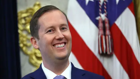Getty Images U.S. Ambassador to India Sergio Gor listens as U.S. President Donald Trump delivers remarks during his swearing-in ceremony in the Oval Office of the White House on November 10, 2025 in Washington, DC. In addition to serving as Ambassador to India, President Trump appointed Gor as Special Envoy to South and Central Asia. Gor previously served as Assistant to the President and Director of Presidential Personnel at the White House. (Photo by Anna Moneymaker