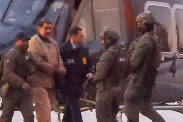 Armed officers escorted Maduro to court.