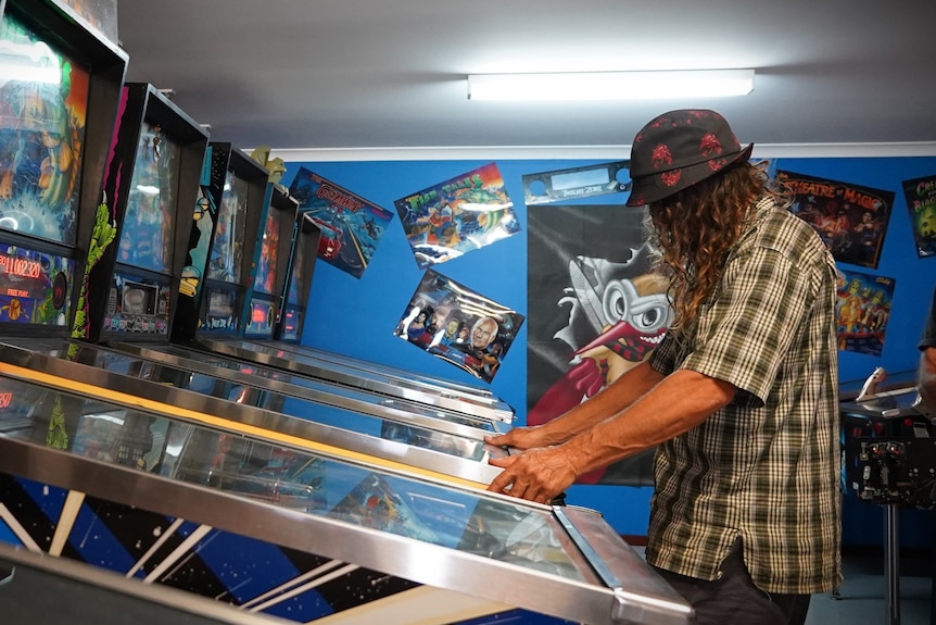 Azza Williamson plays pinball. 